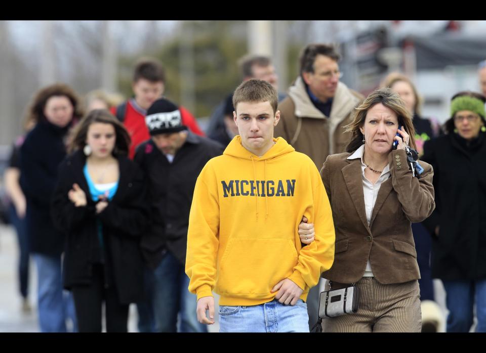 Students leave with parents from Maple Elementary School after a shooting at Chardon High School Monday. Students assembled at Maple Elementary School after a shooting took place at the high school. A gunman opened fire inside the high school's cafeteria at the start of the school day, killing three students and wounding two others, officials said. A suspect is in custody. (AP Photo/Tony Dejak)