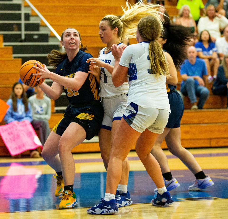 Annika Andersen, of the Naples High School basketball team drives to the basket against Barron Collier during the District 5A-12 Girls Basketball championship game at Barron Collier High School.