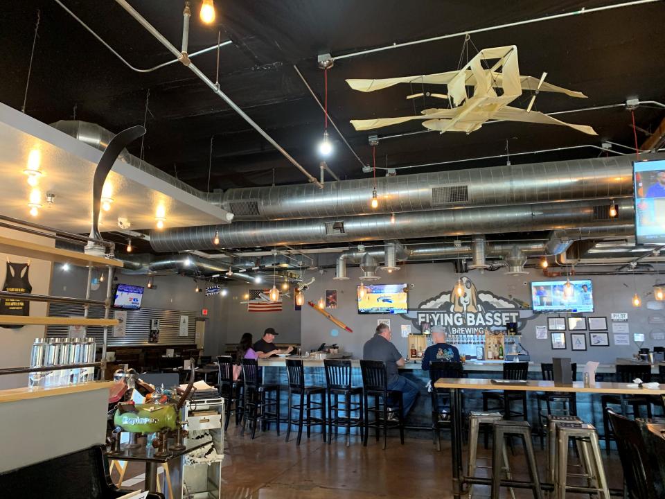 Flying Basset Brewing is named after the owners' two passions, flying planes and basset hounds. The interior features plane models and flying memorabilia among brewing equipment.