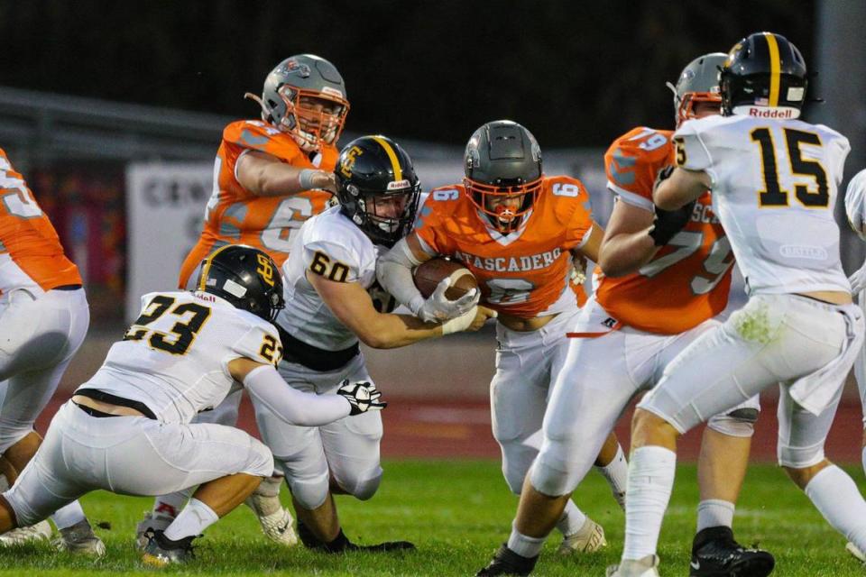 Diego Real runs with the football as Garrett Hall reaches to tackle. Atascadero won in a football game with San Luis Obispo 28-24 Sep., 23, 2022.