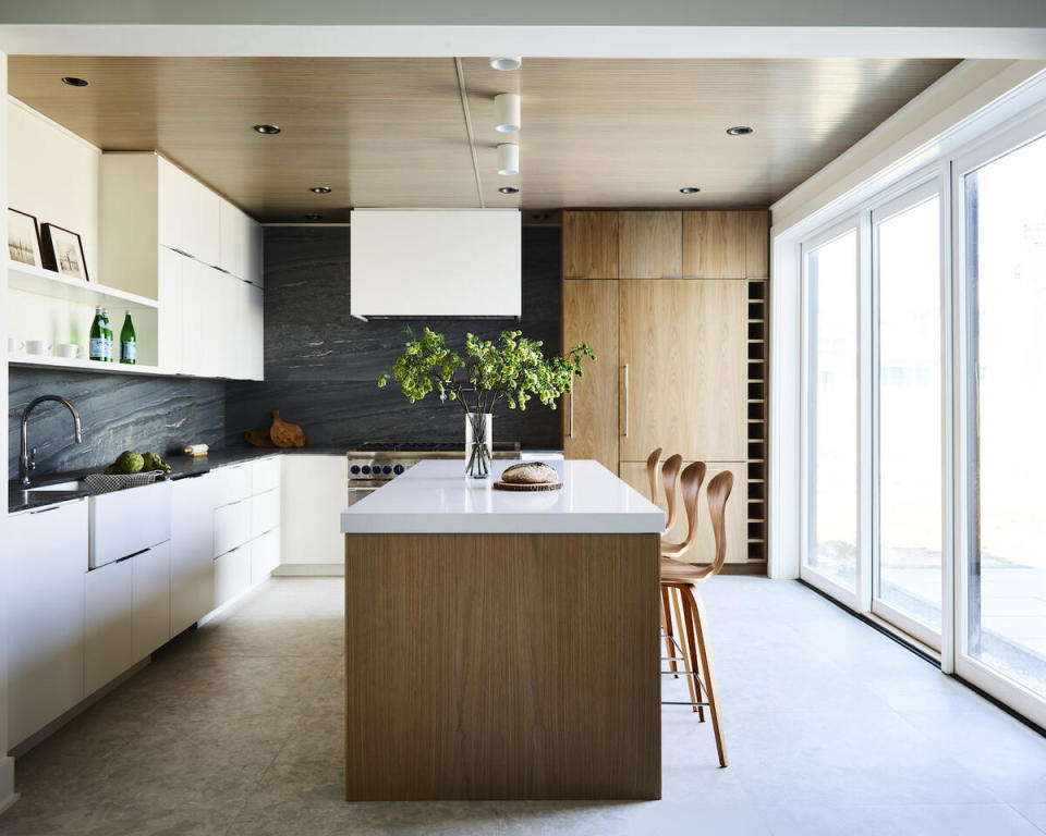 Natural materials mimic the landscape visible out the sliding doors, which open onto the harbor