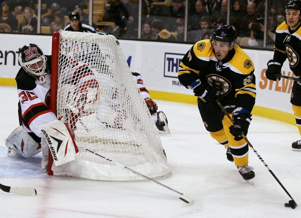 BOSTON - NOVEMBER 15: Brad Marchand #63 of the Boston Bruins wraps around the net as Martin Brodeur #30 of the New Jersey Devils defends on November 15, 2010 at the TD Garden in Boston, Massachusetts. (Photo by Elsa/Getty Images)