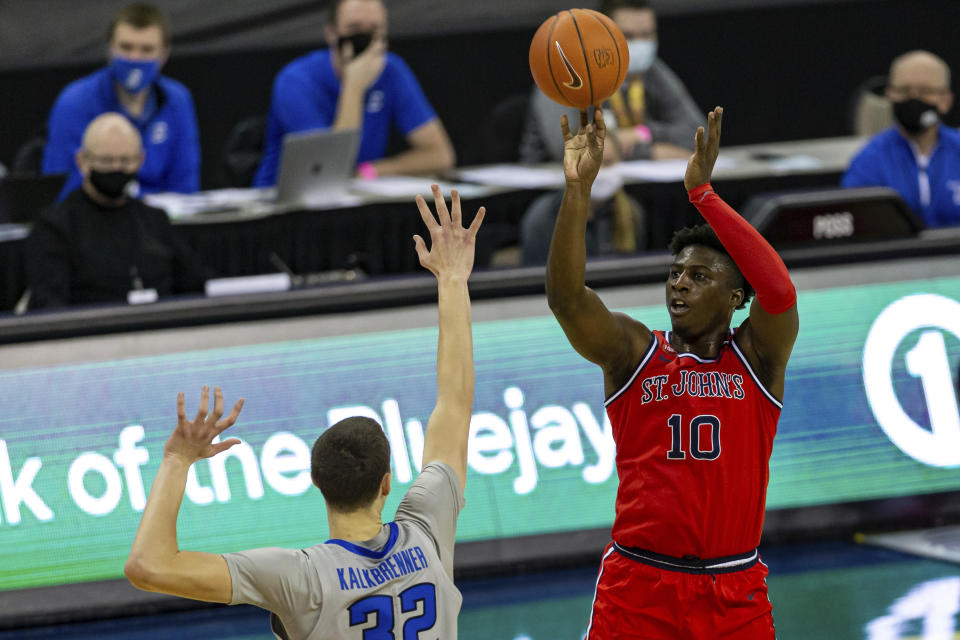 St. John's forward Marcellus Earlington (10) shoots over Creighton center Ryan Kalkbrenner (32) in the first half of an NCAA college basketball game, Saturday, Jan. 9, 2021, in Omaha, Neb. (AP Photo/John Peterson)