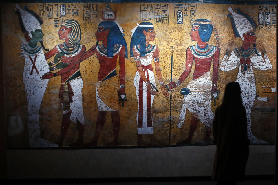 A visitor walks in 'Tutankhamun, the treasure of the Pharaoh', an exhibition in partnership with the Grand Egyptian Museum at the Grande Halle of La Villette in Paris, France, Thursday, March 21, 2019. This exhibition, which runs from 23 March to 15 September 2019. will reveal 150 fascinating original objects found in 1922 in the tomb of the most famous Pharaoh. (AP Photo/Francois Mori)