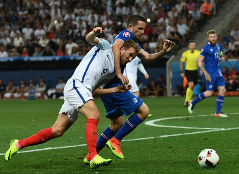 England's forward Harry Kane (L) and Iceland's defender Kari Arnason vie for the ball during the Euro 2016 round of 16 football match between England and Iceland at the Allianz Riviera stadium in Nice on June 27, 2016