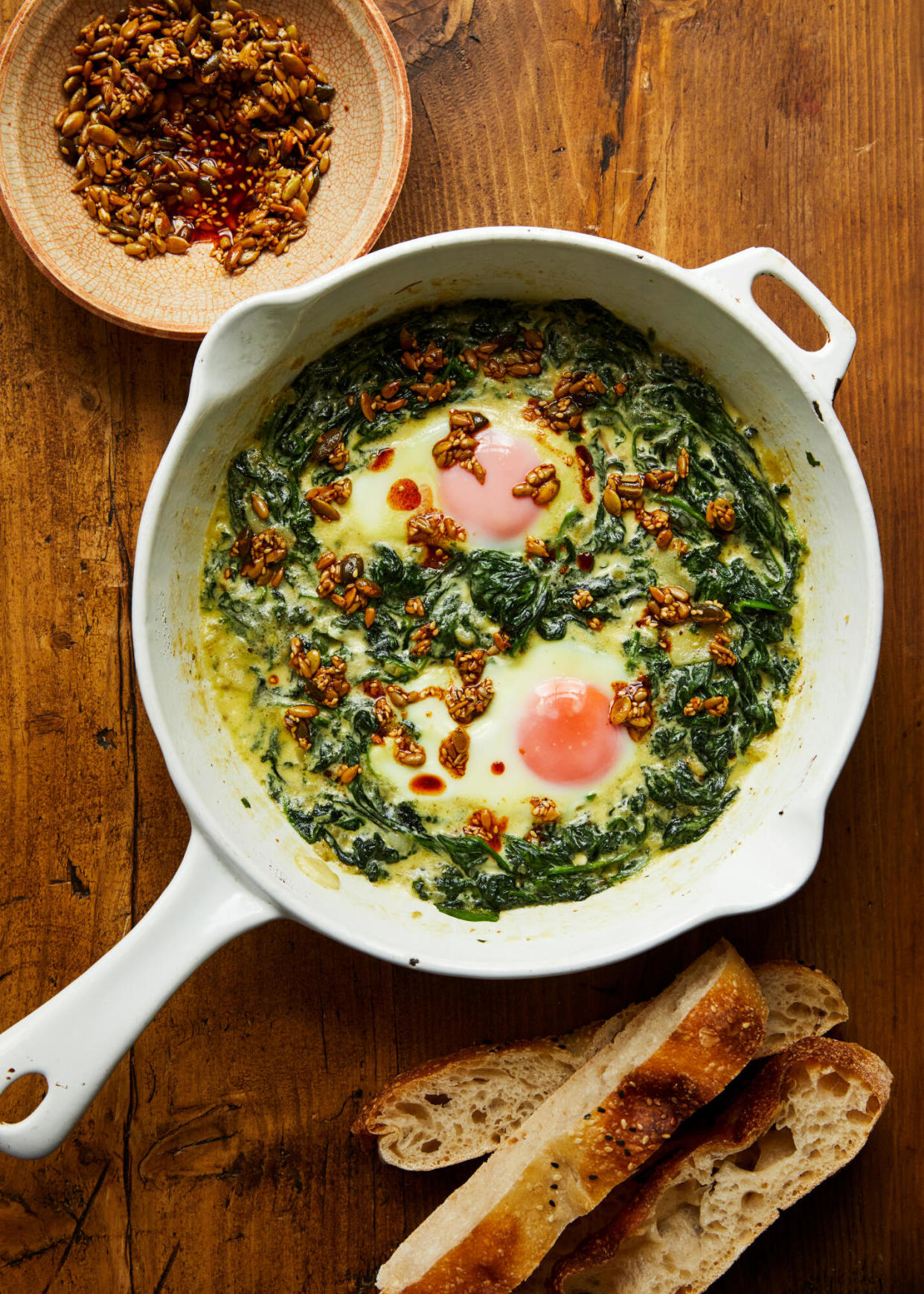 <span>Ed Smith’s eggs in creamed spinach with spiced butter seeds.</span><span>Photograph: Sam A Harris/Hardie Grant. Food styling: Sam Dixon. Prop styling: Anna Wilkins.</span>