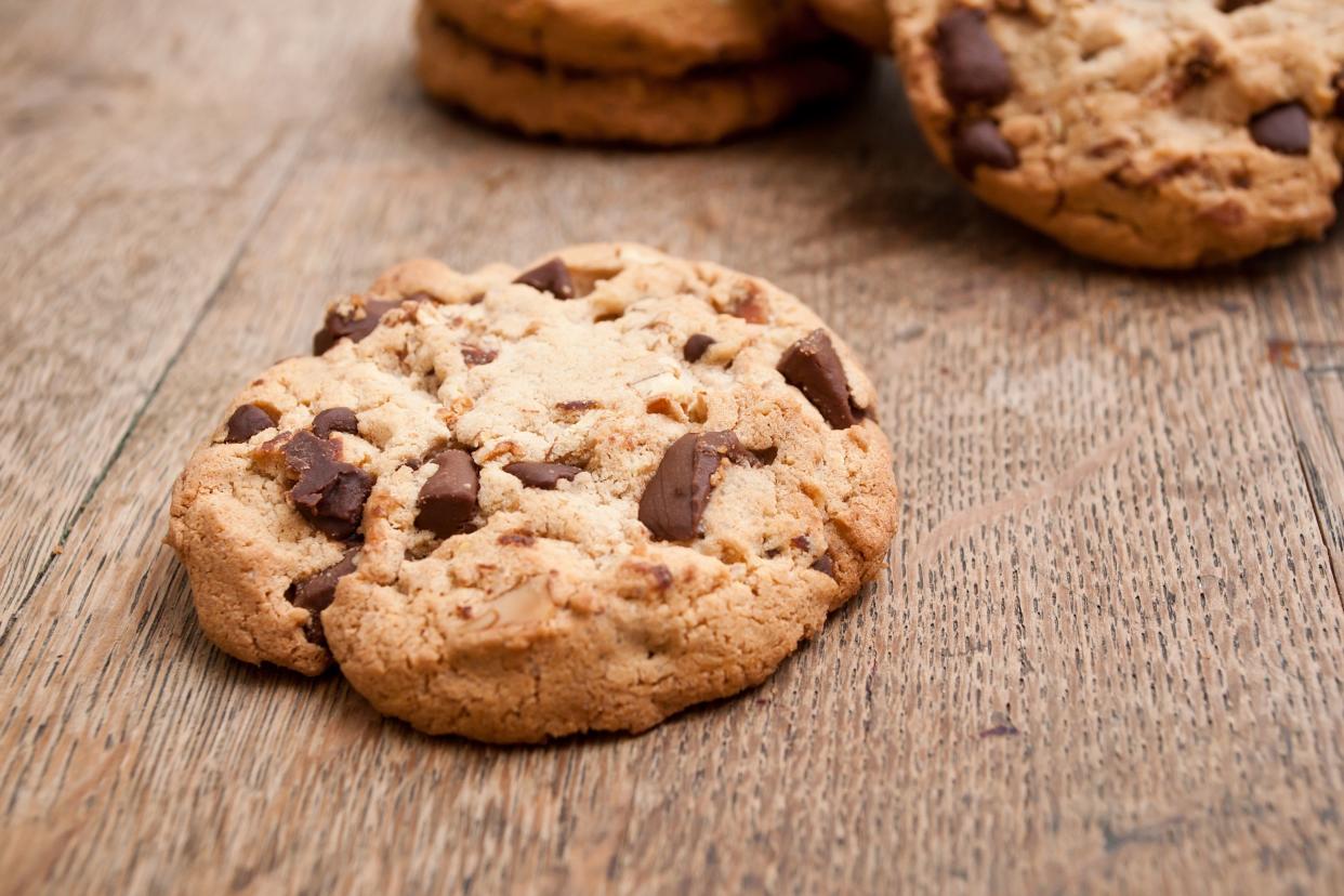 chewy chocolate chip cookies on wooden surface