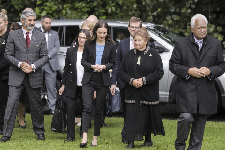 Finland's Prime Minister Sanna Marin, centre, is met by dignitaries for her welcome ceremony at the Auckland Museum, in Auckland, New Zealand, Wednesday, Nov. 30, 2022. Marin says it must give more weapons and support to Ukraine to ensure it wins its war against Russia. (Michael Craig/New Zealand Herald via AP)