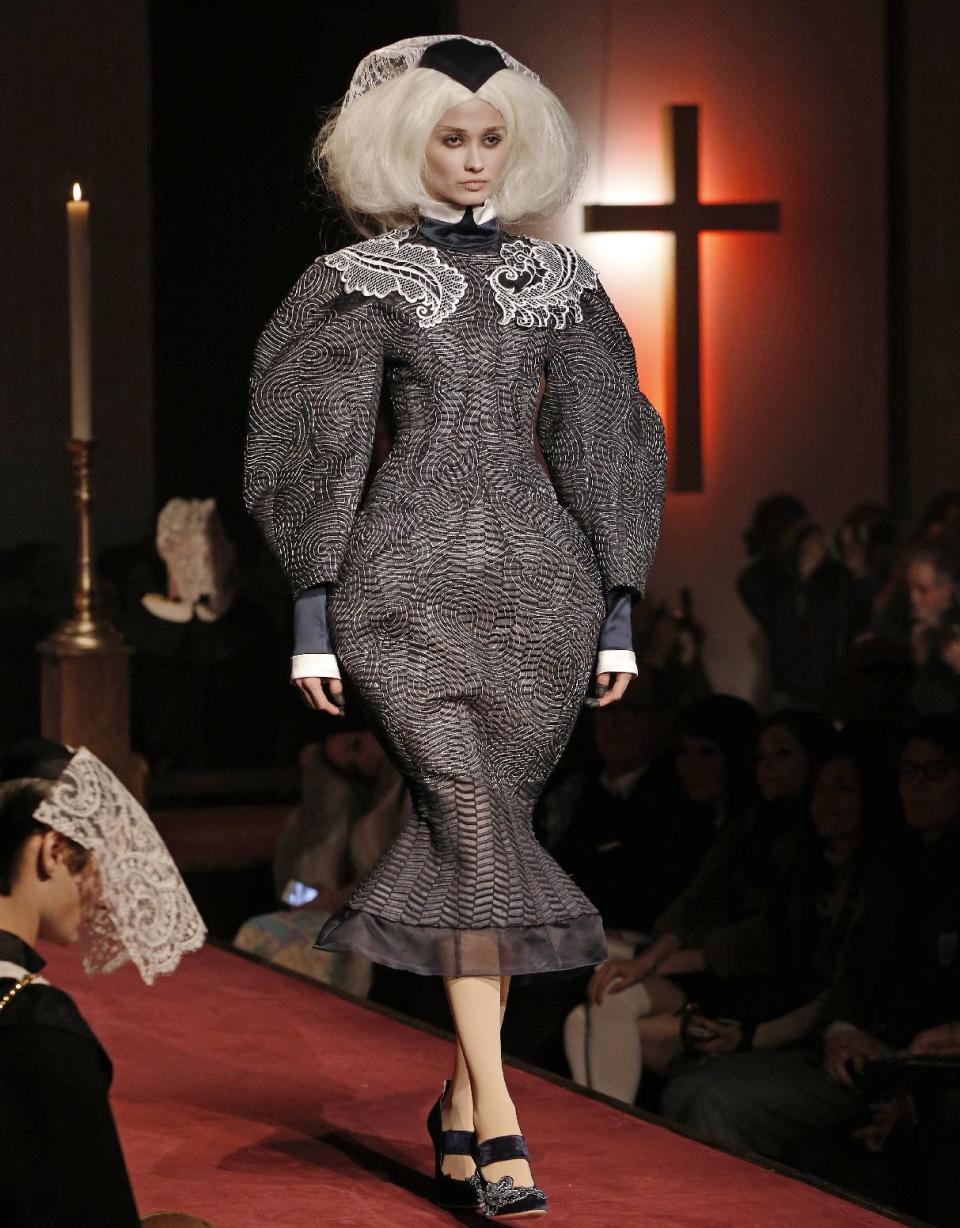 A model walks the runway during the presentation of the Thom Browne Fall 2014 collection in New York, Monday, Feb. 10, 2014. (AP Photo/Kathy Willens)