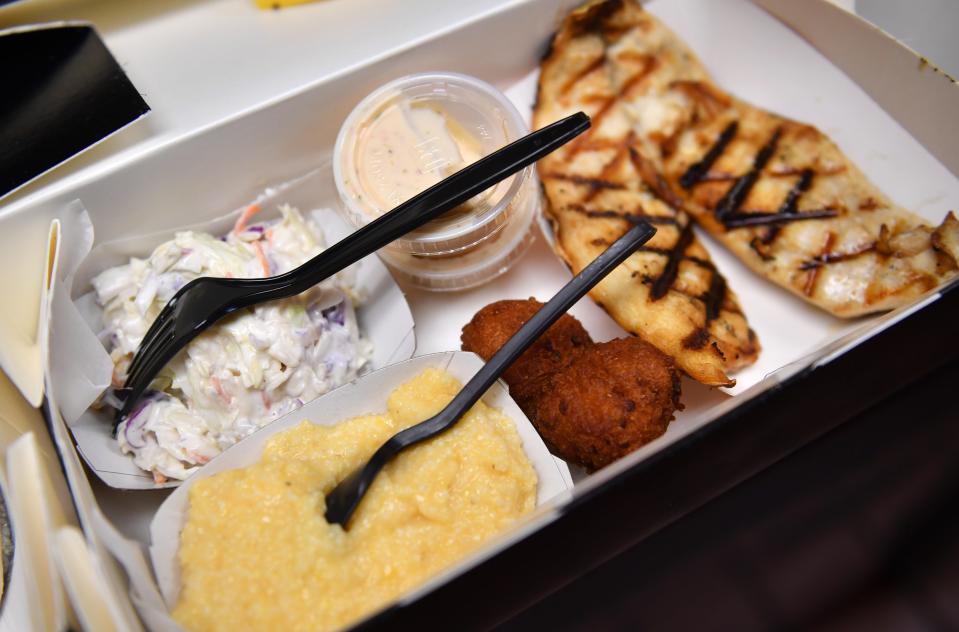 Grilled Florida pompano with hush puppies, cole slaw and cheese grits at the Star Fish Company in Cortez, Florida.