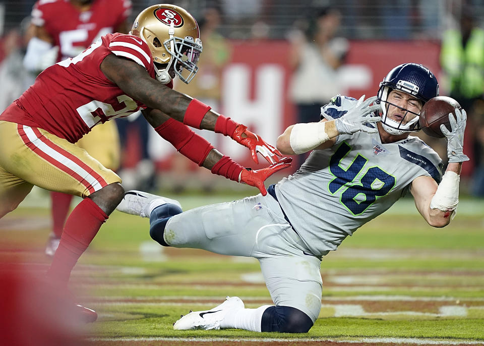 SANTA CLARA, CALIFORNIA - NOVEMBER 11: Tight end Jacob Hollister #48 of the Seattle Seahawks catches a pass for a touchdown over strong safety Jaquiski Tartt #29 of the San Francisco 49ers in the third quarter of the game at Levi's Stadium on November 11, 2019 in Santa Clara, California. (Photo by Thearon W. Henderson/Getty Images)