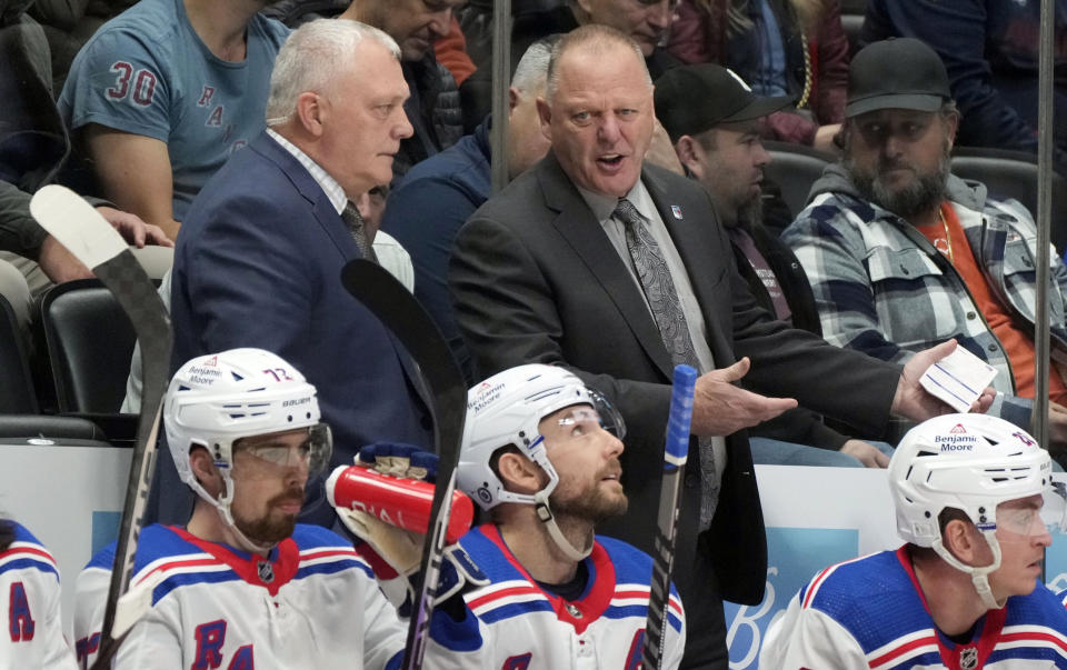 New York Rangers assistant coach Gord Murphy, top left, confers with head coach Gerard Gallant in the second period of an NHL hockey game against the Colorado Avalanche, Friday, Dec. 9, 2022, in Denver. (AP Photo/David Zalubowski)