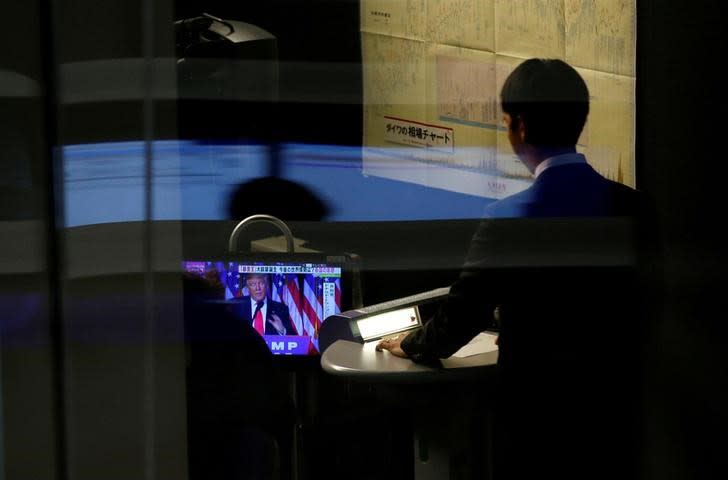 FILE PICTURE: A monitor showing U.S. President-elect Donald Trump speaking on TV is seen at the Tokyo Stock Exchange in Tokyo, Japan, November 10, 2016. REUTERS/Toru Hanai/File Photo