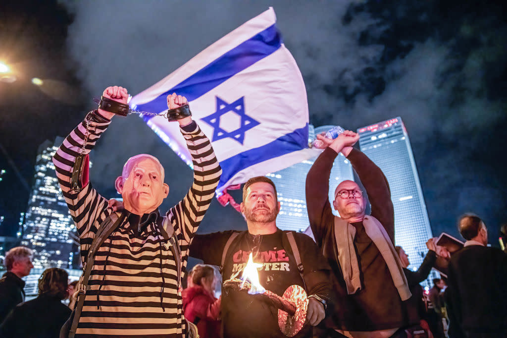 Israeli protester dressed in a convict uniform and a