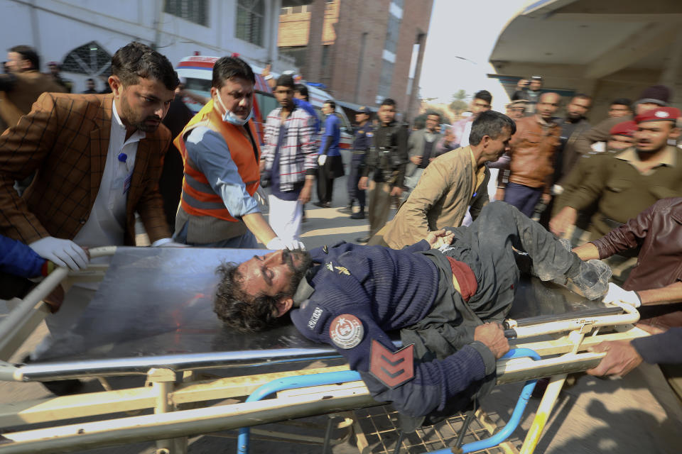 Workers and volunteers carry an injured victim of a suicide bombing upon arrival at a hospital in Peshawar, Pakistan, Monday, Jan. 30, 2023. A suicide bomber struck Monday inside a mosque in the northwestern Pakistani city of Peshawar, killing multiple people and wounding scores of worshippers, officials said. (AP Photo/Muhammad Sajjad)