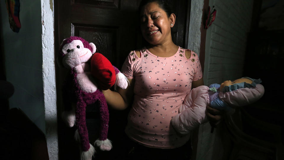 Rosa Ramirez sobs as she shows journalists toys that belonged to her nearly two-year-old granddaughter Valeria who drowned with her father while trying to cross the Rio Grande into the US from Mexico.