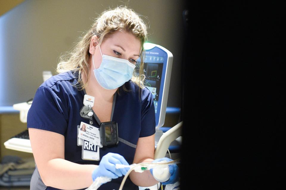 Ashley Branson, a respiratory therapist at the University of Tennessee Medical Center, checks on a patient.