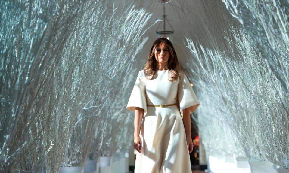 US First Lady Melania Trump walks through Christmas decorations in the East Wing as she tours holiday decorations at the White House in Washington, DC, on November 27, 2017.