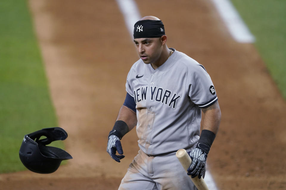 New York Yankees' Rougned Odor tosses his helmet and looks to the dugout after striking out during the seventh inning of the team's baseball game against the Texas Rangers in Arlington, Texas, Tuesday, May 18, 2021. (AP Photo/Tony Gutierrez)