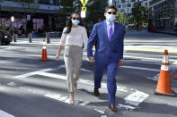 Former Fall River, Mass. Mayor Jasiel Correia, right, and his wife Jenny Fernandes, arrives for a court appearance at the John Joseph Moakley United States Courthouse, Monday, Sept. 20, 2021, in Boston. Correia, who was elected at the age of 23 with promises to rejuvenate the struggling mill city, was scheduled to be sentenced for stealing from investors in a smartphone app he created and extorting hundreds of thousands of dollars in bribes from marijuana businesses. (AP Photo/Josh Reynolds)