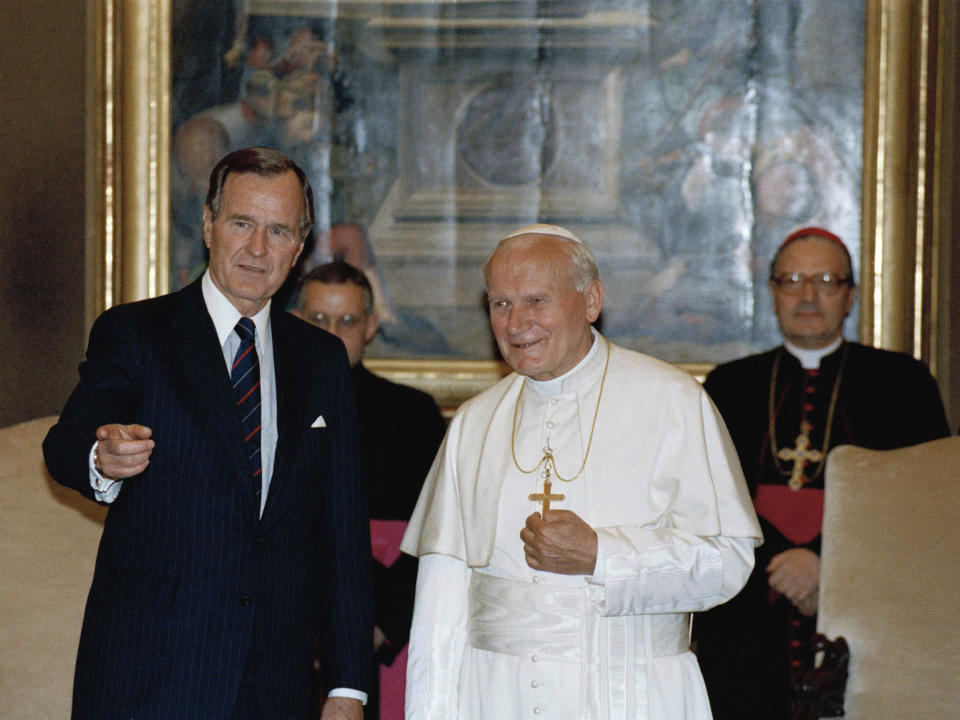 FILE - In this May 27, 1989, file photo, President George Bush, Sr. gestures while standing with Pope John Paul II in the papal library at the Vatican. President Obama is scheduled to meet Pope Francis for the first time on Thursday, March 27, 2014, at the Vatican. (AP Photo/Ron Edmonds, File)