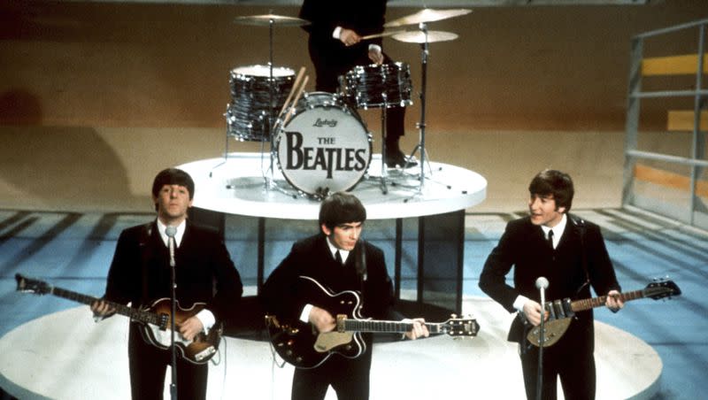 The Beatles, foreground from left, Paul McCartney, George Harrison, John Lennon and Ringo Starr on drums perform on the CBS “Ed Sullivan Show” in New York on Feb. 9, 1964. Sixty years after the onset of Beatlemania and with two of the quartet now dead, artificial intelligence has enabled the release of a “new” Beatles song.