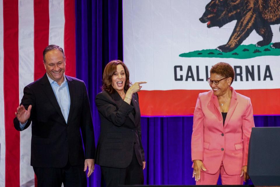 Rep. Karen Bass, right, with Vice President Kamala Harris, center, and Second Gentleman Douglas Emhoff at a rally.