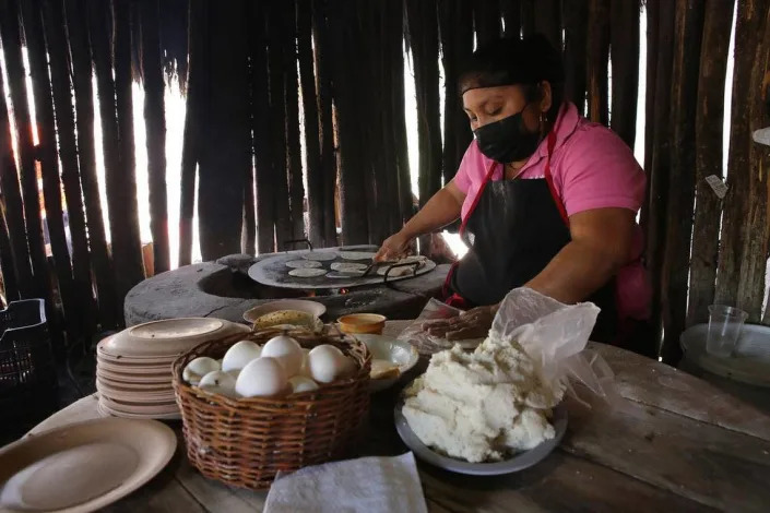 A woman prepares tortillas at the La Tía de Kaua restaurant in Tikuch, Valladolid, Yucatán.