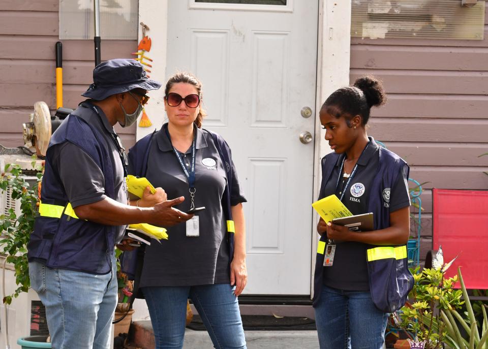Members of a Federal Emergency Management Agency Disaster Survivor Assistance Team confer while canvassing neighborhoods off of Newfound Harbor Drive on Merritt Island on their post-Hurricane Ian assignment.