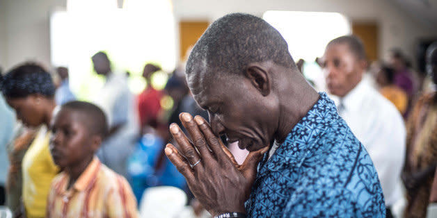 MONROVIA, LIBERIA - OCTOBER 12:  A Christian prays for the people who died due to Ebola, on a ritual in St. Joseph Parish Catholic Church in Monrovia, Liberia on 12 October, 2014. (Photo by Mohammed Elshamy/Anadolu Agency/Getty Images) (Photo: )