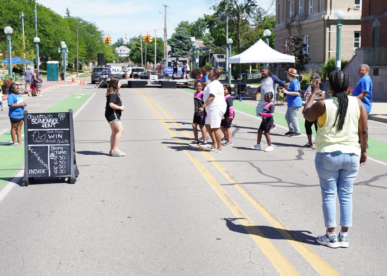 A group of line dancers takes to the street June 18, 2022, during the Juneteenth celebration in downtown Adrian.