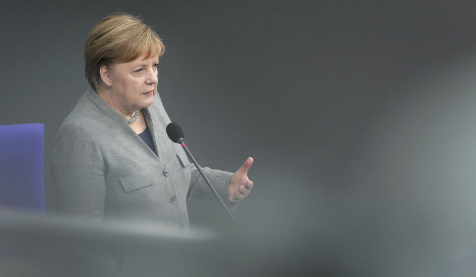 German Chancellor Angela Merkel takes questions as part of a meeting of the German parliament, Bundestag, at the Reichstag building in Berlin, Germany, Wednesday, Dec. 18, 2019. (AP Photo/Michael Sohn)