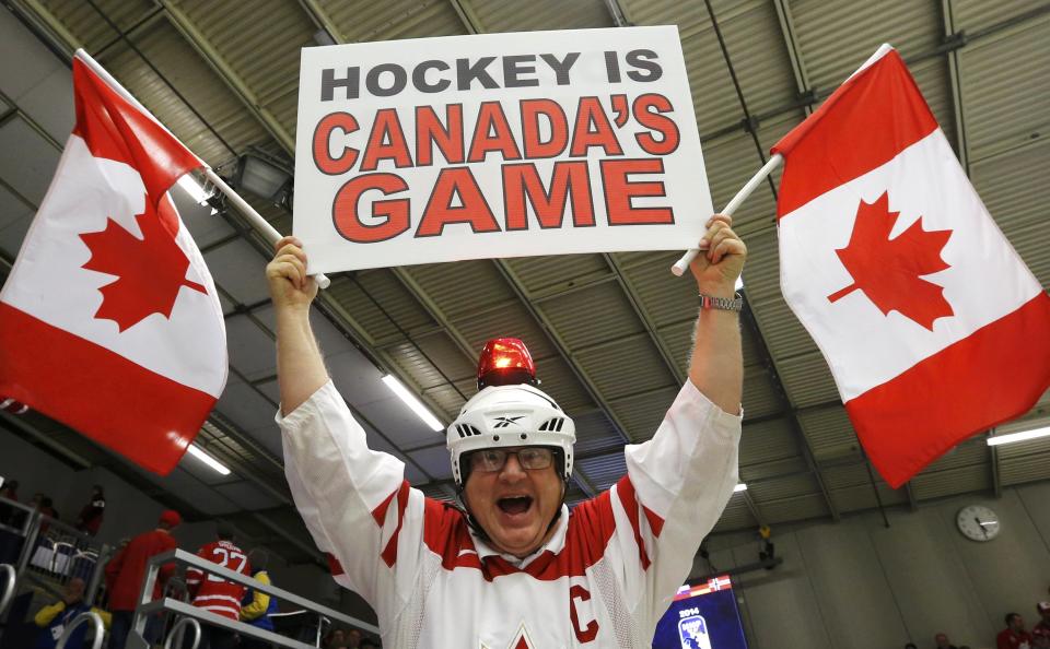 A Canadian fan cheers during play between Canada and the Czech Republic during the first period of their IIHF World Junior Championship ice hockey game in Malmo, Sweden, December 28, 2013. REUTERS/Alexander Demianchuk (SWEDEN - Tags: SPORT ICE HOCKEY)