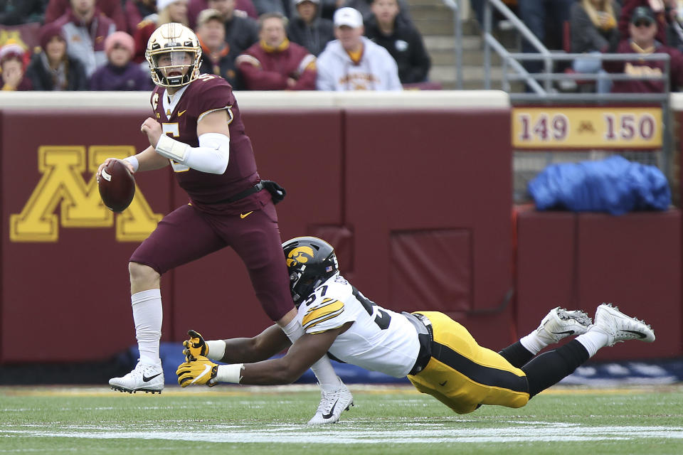 Minnesota quarterback Zack Annexstad tries to avoid a tackle by Iowa's Chauncey Golston during an NCAA college football game Saturday, Oct. 6, 2018, in Minneapolis. (AP Photo/Stacy Bengs)