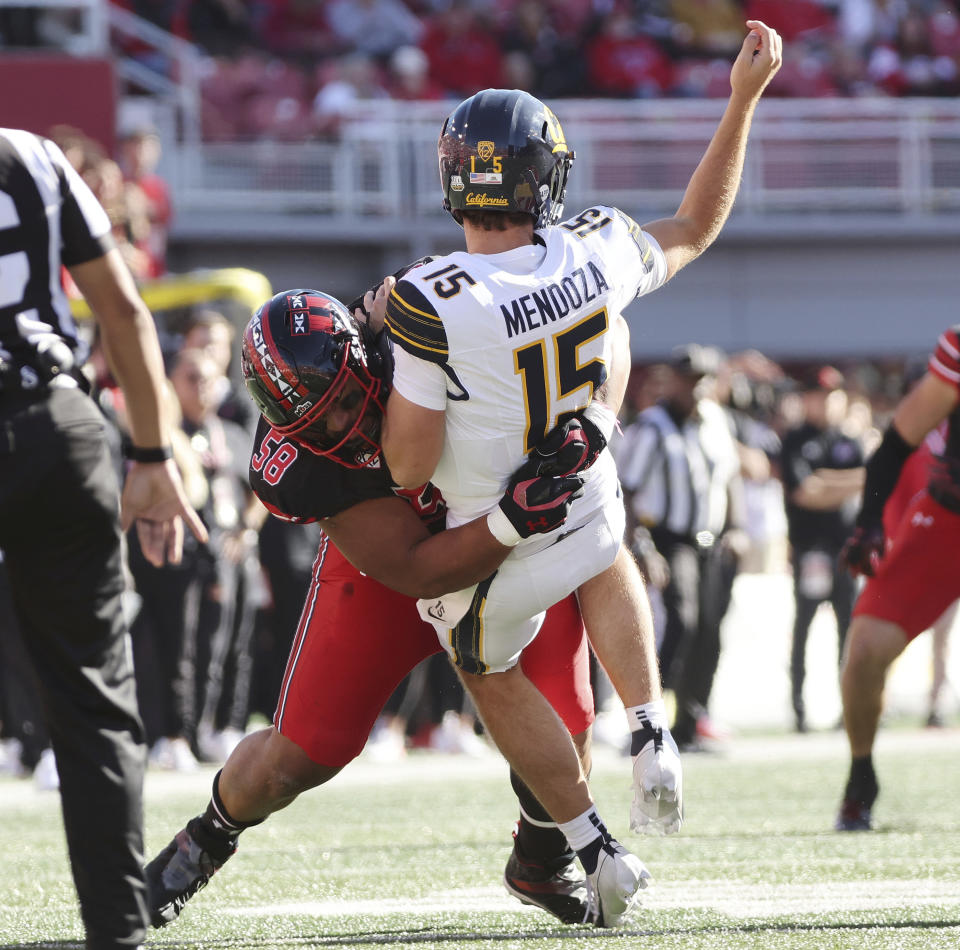 Utah defensive tackle Junior Tafuna (58) hurries California quarterback Fernando Mendoza (15) who was injured during an NCAA college football game Saturday. Oct. 14, 2023, in Salt Lake City. (Jeffrey D. Allred/The Deseret News via AP)