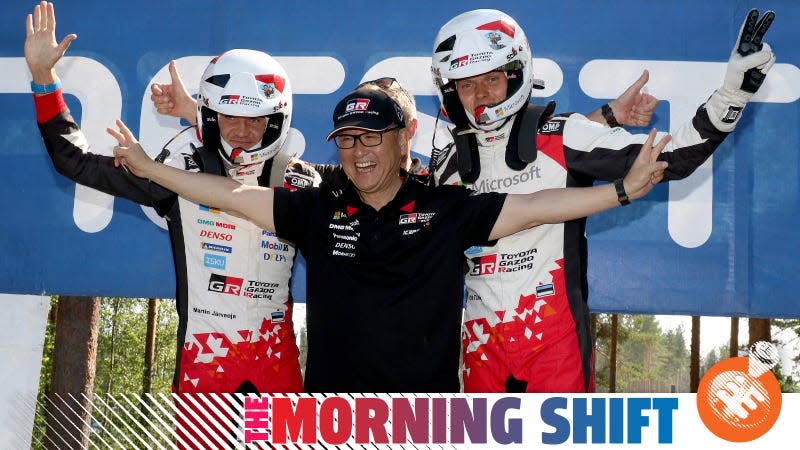 Ott Tanak, right, and Martin Jarveoja, left, celebrate their victory with Toyota President Akio Toyoda after day four of the 2018 WRC Rally Finland.