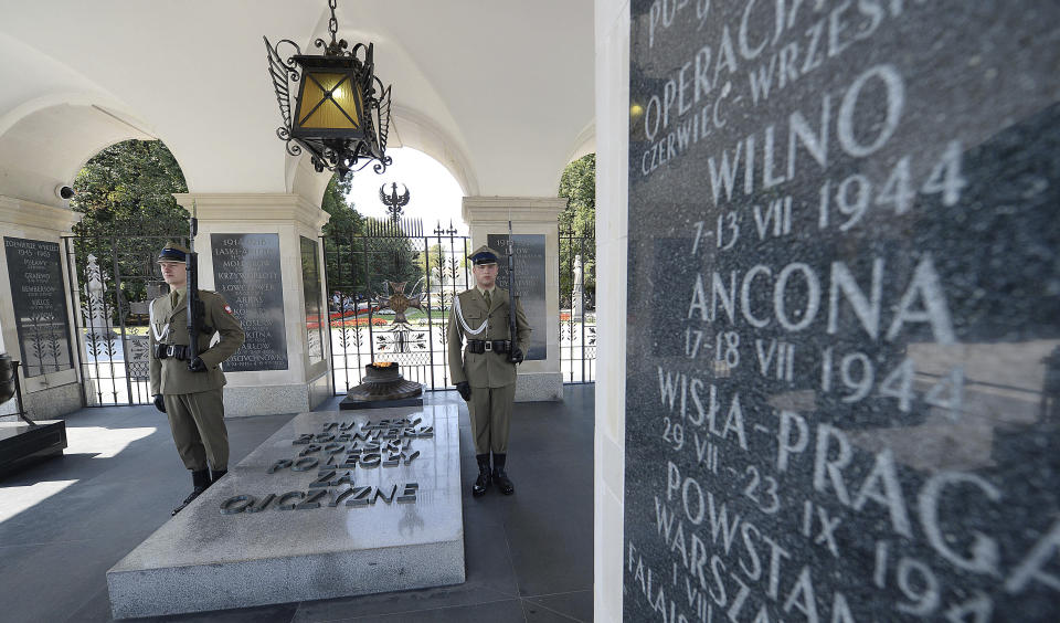 Polish soldiers stand guard at the Tomb of the Unknown Soldier at Pilsudski Square in Warsaw, Poland, Tuesday, Aug. 27, 2019. The square will be the site of commemorations Sunday marking the 80th anniversary of the start of World War II, to be attended by over 40 world leaders, including President Donald Trump. (AP Photo/Czarek Sokolowski)