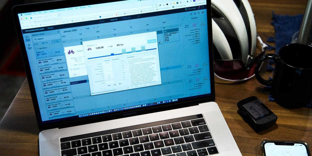 training peaks on a computer screen with cycling accessories on a table