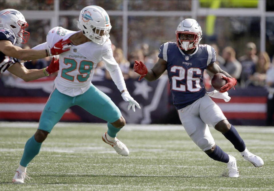 New England Patriots running back Sony Michel (26) runs past Miami Dolphins defensive back Minkah Fitzpatrick (29) during the first half of an NFL football game, Sunday, Sept. 30, 2018, in Foxborough, Mass. (AP Photo/Steven Senne)