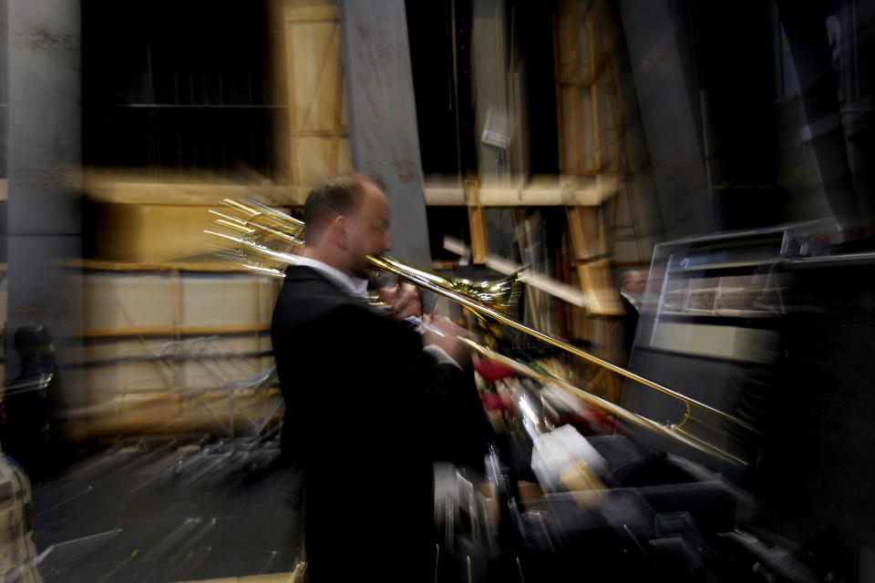 Musician of the National Symphony Orchestra (NSO) plays his instrument at the backstage prior to the start of the concert at Milan's La Scala theatre, Italy, Monday, Feb. 26, 2024. (AP Photo/Antonio Calanni)