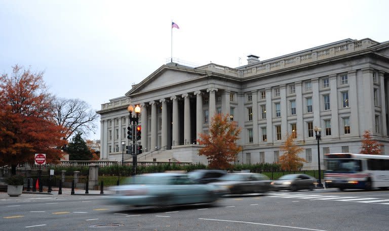 Vehicles drive by the US Treasury Building in Washington on November 15, 2011. Treasury Secretary Timothy Geithner has warned the nation will reach its $16.39 trillion debt limit on December 31