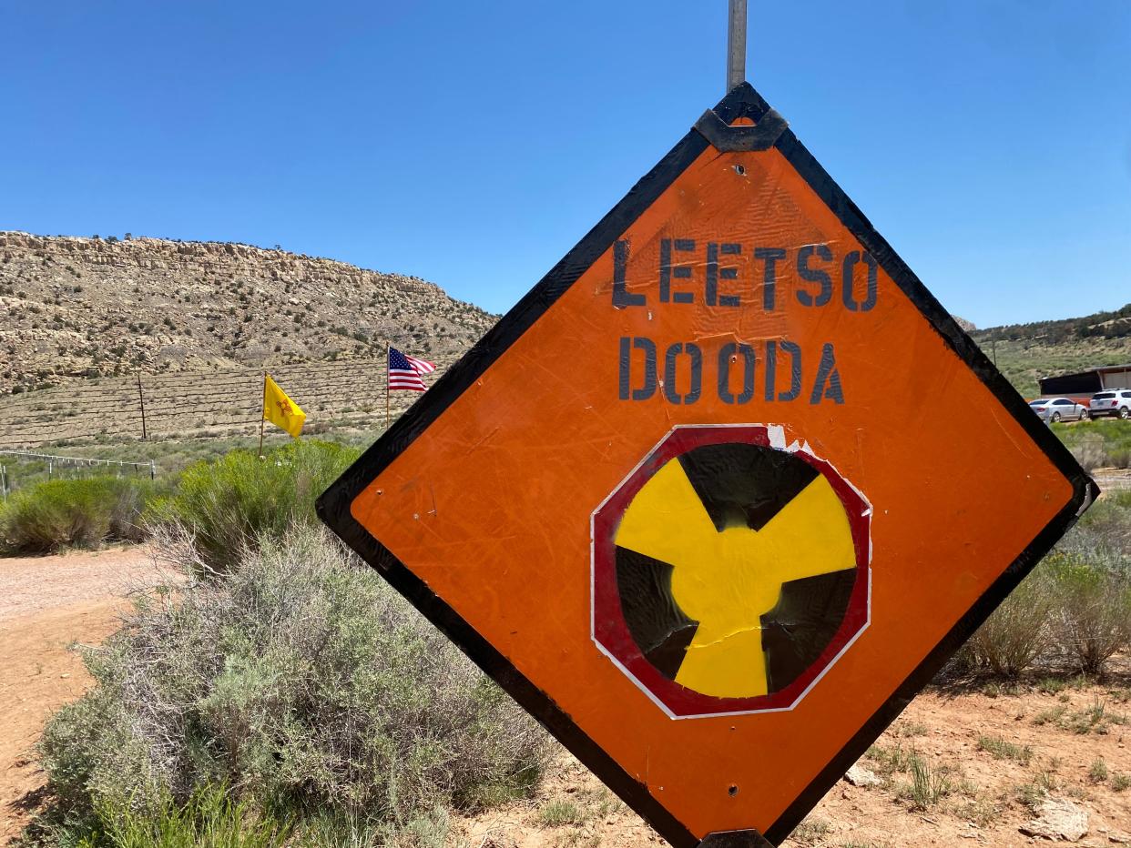 A sign reading Leesto Dooda, meaning no uranium, greets people who attended the Uranium Tailings Spill Legacy Commemoration at Red Water Pond Road community.