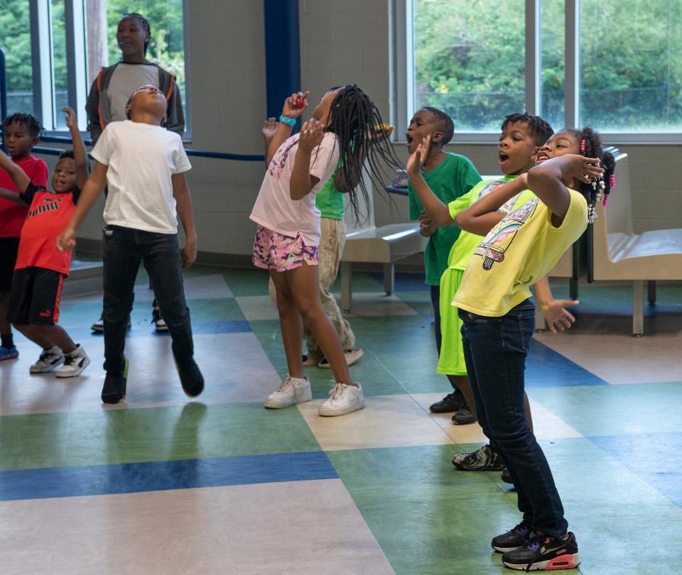 Third-grader Ny'Cavia Davis, right, and others chant and sing Wednesday during the Central Gulf Coast Children's Defense Fund Freedom School's morning Harambee — which means "all pull together" in Swahili — at the Global Learning Academy in Pensacola.