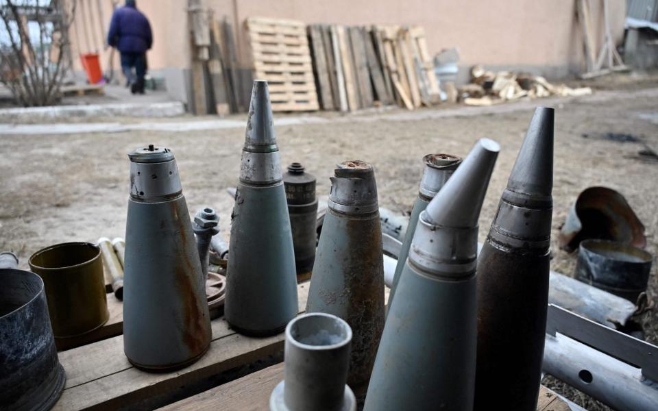 A photo shows various types of ammunition shells as a local resident collects ammunition remains in Tsirkuny village, Kharkiv - SERGEY BOBOK/AFP