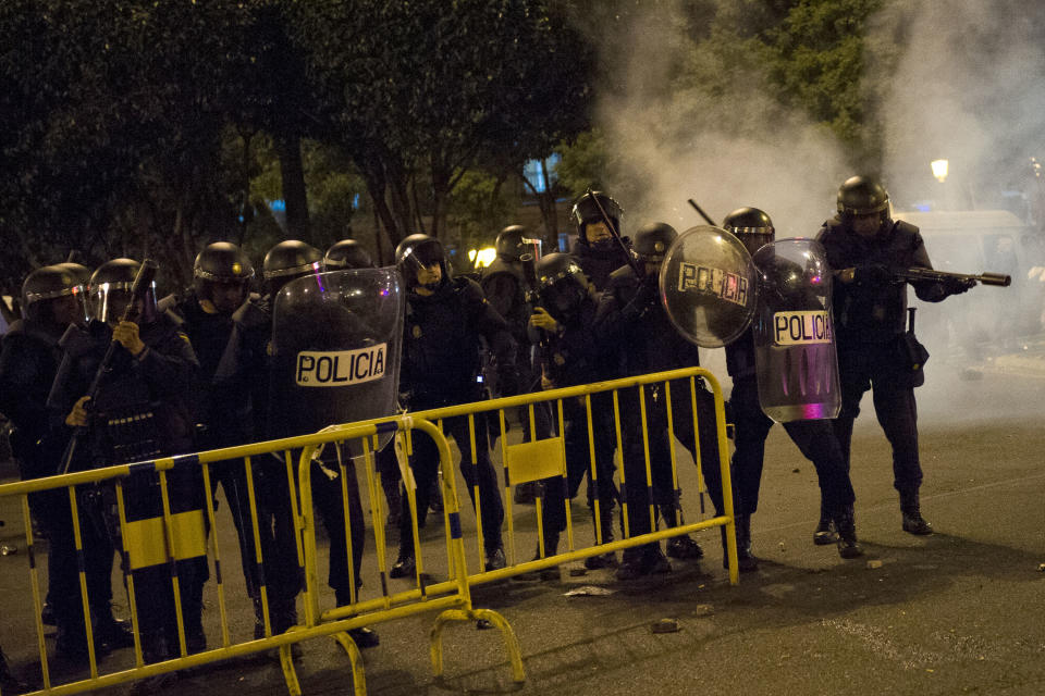 Spanish Police shoot rubber balls during riots after demonstrators marched to the Spanish Parliament against the austerity measures announced by the Spanish government in Madrid, Spain, Tuesday, Sept. 25, 2012. Spain's government was hit hard by the country's financial crisis on multiple fronts Tuesday as protestors enraged with austerity cutbacks and tax hikes clashed with police near Parliament, a separatist-minded region set elections seen as an independence referendum and the nation's high borrowing costs rose again. (AP Photo/Daniel Ochoa De Olza)