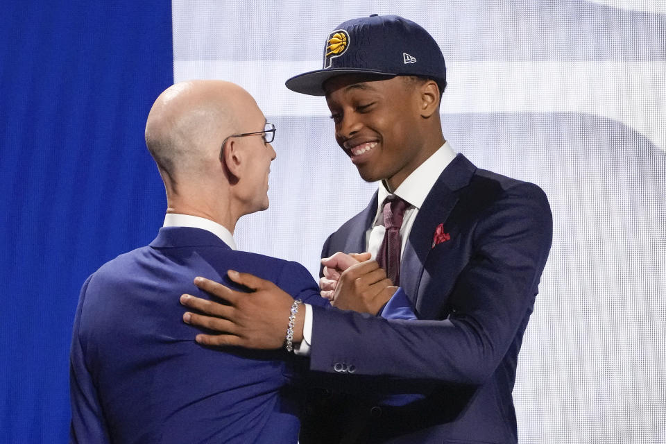 Bilal Coulibaly greets NBA Commissioner Adam Silver after being selected seventh overall by the Indiana Pacers during the NBA basketball draft, Thursday, June 22, 2023, in New York. (AP Photo/John Minchillo)