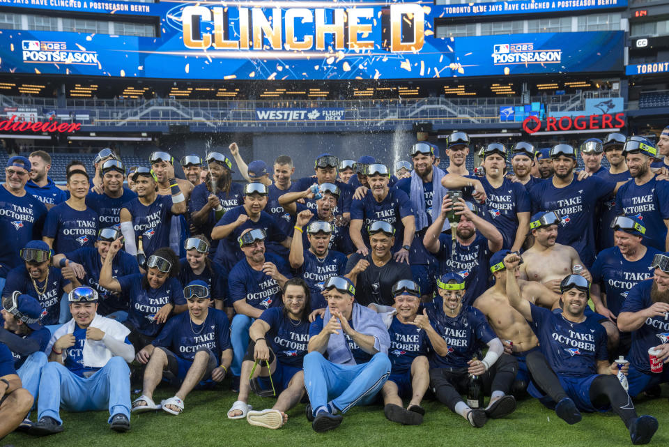 Toronto Blue Jays celebrate after clinching a berth in the AL wild card series following a baseball game against the Tampa Bay Rays in Toronto, Sunday, Oct. 1, 2023. (Frank Gunn/The Canadian Press via AP)