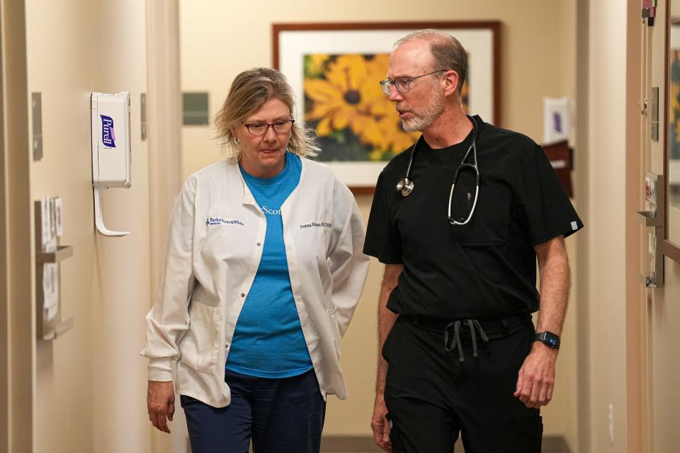 Dr. Christopher Stewart and Donna Ekman, an anticoagulation clinic nurse, walk the halls at the Baylor Scott & White Clinic in Cedar Park.