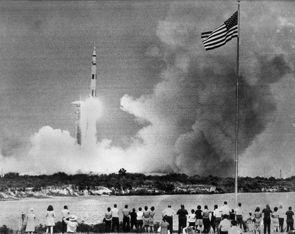 FILE - In this April 11, 1970 file photo, crowds watch the lift-off of the Saturn V rocket carrying the Apollo 13 spacecraft on its mission to the moon from Cape Kennedy, Fla. (AP Photo)