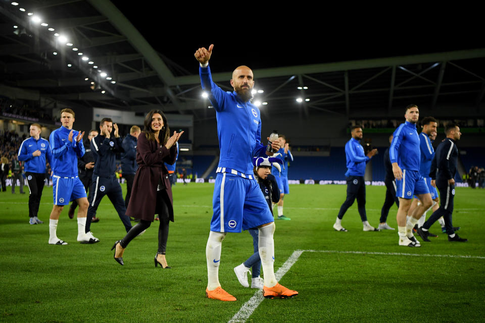 Brighton players celebrate with fans after beating Manchester United last Friday to ensure Premier League survival